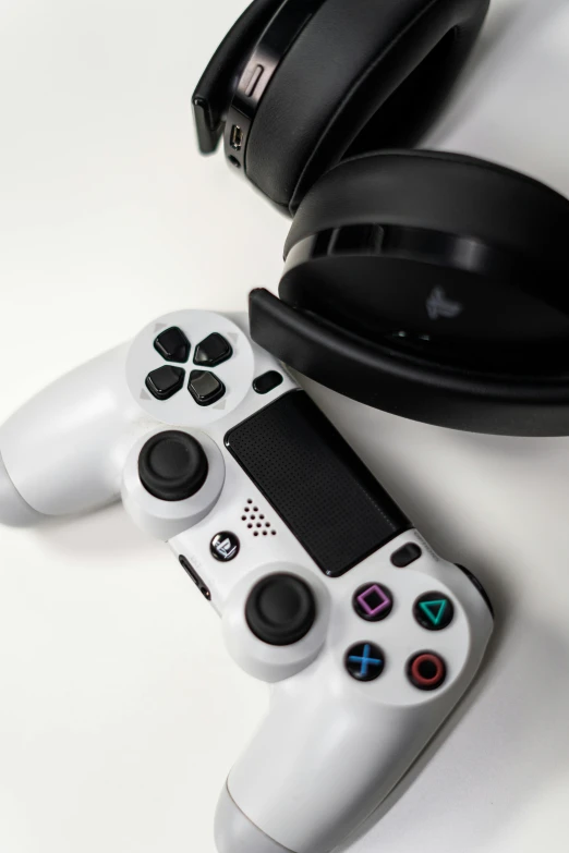 a couple of video game controllers sitting next to each other, a picture, with head phones, white and black, taken with sony alpha 9, no - text no - logo