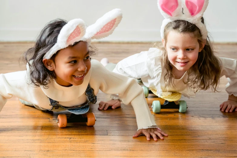 two little girls wearing bunny ears on skateboards, inspired by Elsa Beskow, pexels contest winner, crawling towards the camera, diverse costumes, easter, white