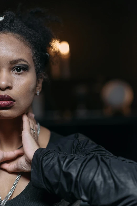 a woman in a black top posing for a picture, an album cover, trending on unsplash, pouty lips, mixed race, dramatic lighting; 4k 8k, close-up portrait film still