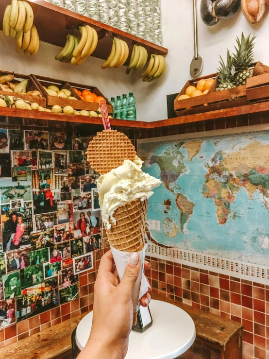 a person holding an ice cream cone in a kitchen, around the world, 🚿🗝📝, tourist photo, made of glazed