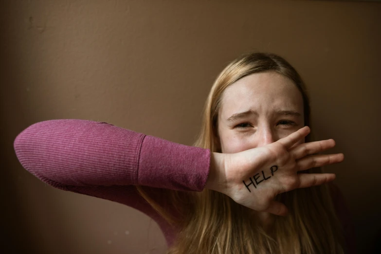 a woman covering her face with her hands, trending on pexels, graffiti, saoirse ronan, hand over mouth, britt marling style 3/4, teenager