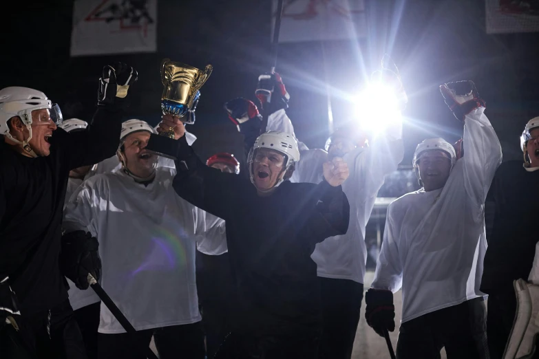 a group of men standing next to each other holding up a trophy, by Jaakko Mattila, pexels contest winner, happening, nhl, set at night, production still, a still of a happy