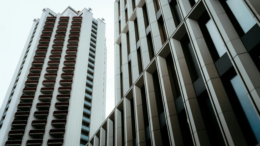 a couple of tall buildings next to each other, inspired by Thomas Struth, unsplash, brutalism, brown, high quality photo, lachlan bailey, exterior photo