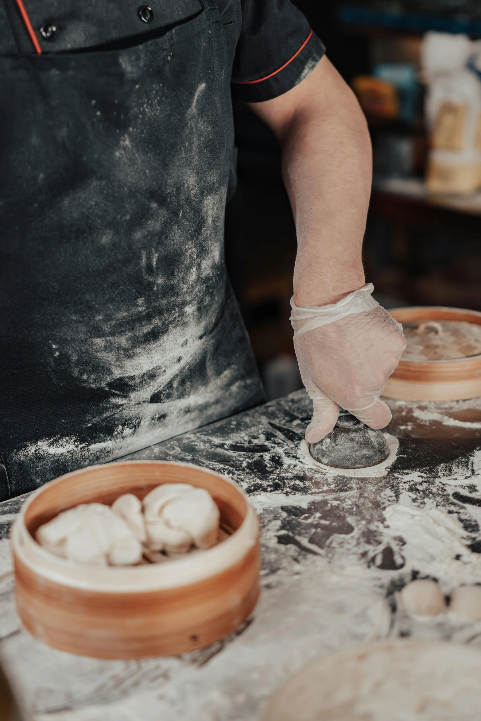 a man in a black shirt is making dumplings, inspired by Cheng Zhengkui, trending on unsplash, process art, white clay, thumbnail, loaves, round-cropped