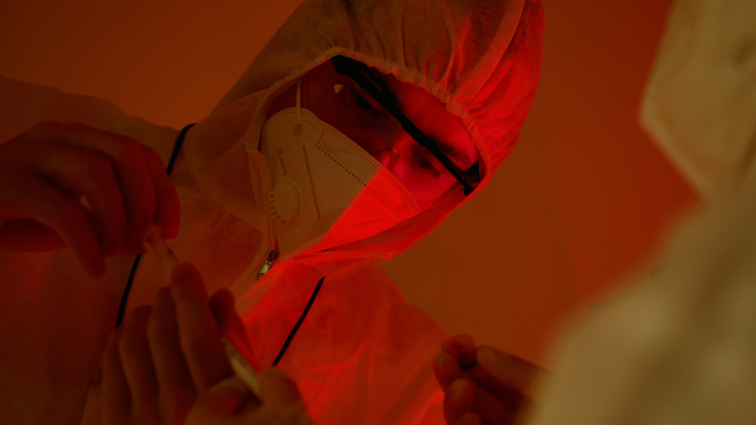 a close up of a person in a protective suit, pexels, process art, detailed red lighting, wearing lab coat and glasses, investigation, thumbnail