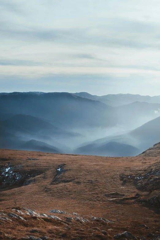 a couple of people standing on top of a mountain, a matte painting, by Adam Marczyński, unsplash contest winner, romanticism, early morning light, rolling foothills, 4k panoramic, new zealand