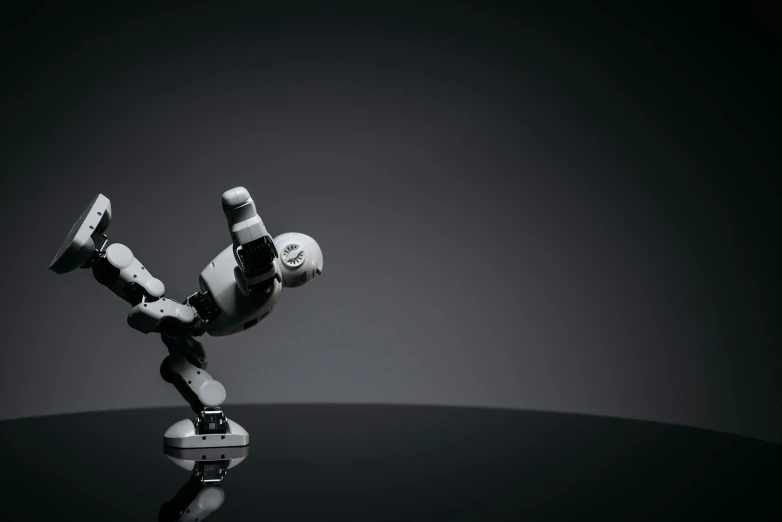 a black and white photo of a robot doing a handstand, unsplash, visual art, painted action figure, 3d render 8k, from star wars legends, elegant floating pose
