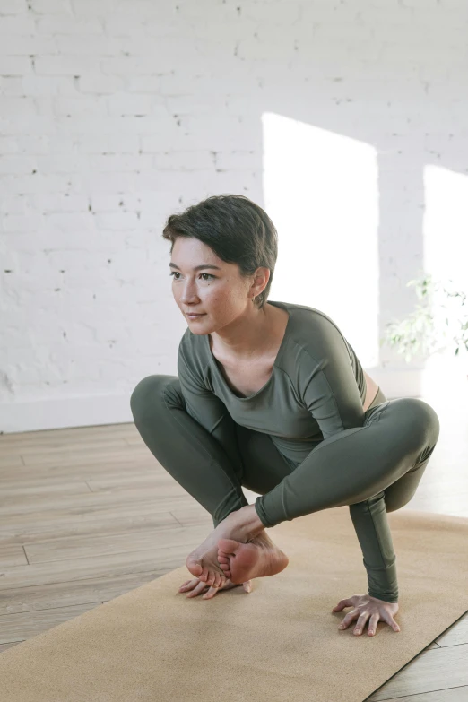 a woman doing a yoga pose on a yoga mat, inspired by Fei Danxu, profile image, default pose neutral expression, fissures, instagram photo