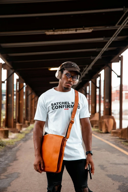 a man standing on a street holding a skateboard, an album cover, by Everett Warner, shutterstock contest winner, wearing an orange t-shirt, holding a leather purse, white t-shirt, trending on r/techwearclothing