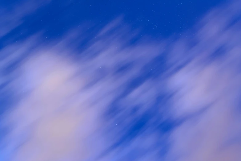 a large jetliner flying through a blue sky, by Carey Morris, pexels contest winner, light and space, night clouds, an abstract, blue blurred, today\'s featured photograph 4k