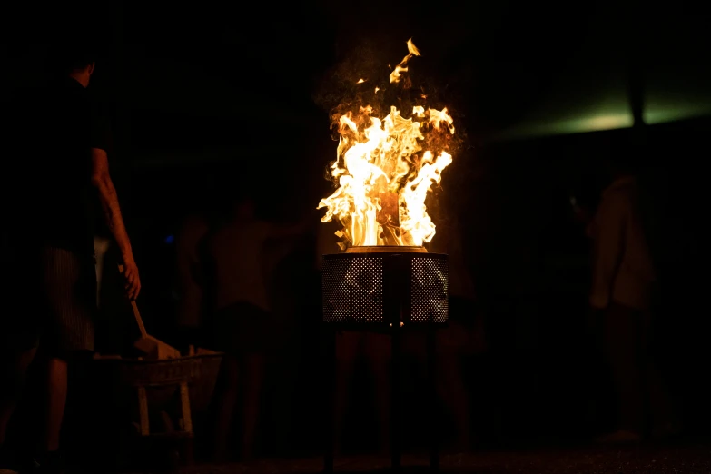 a group of people standing around a fire pit, performance art, a person at a music festival, profile image, technical