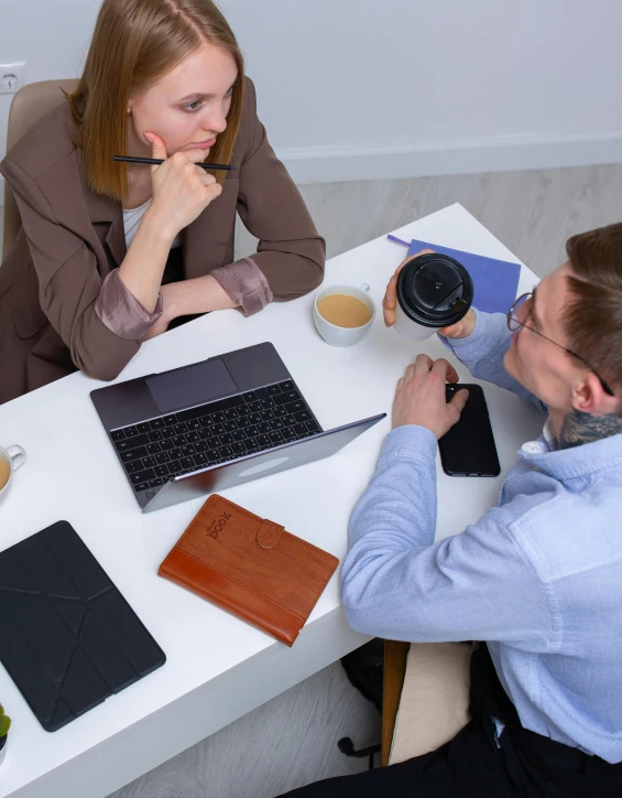 a couple of people that are sitting at a table, on desk