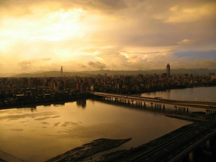 a large body of water next to a city, by Matt Stewart, pexels contest winner, hurufiyya, dramatic golden light, taiwan, from egypt, slide show