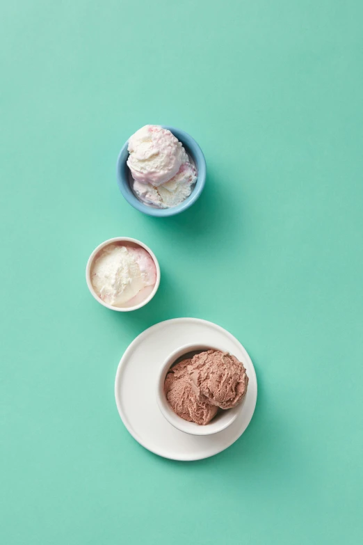 three bowls of ice cream on a green surface, brown and pink color scheme, detailed product image, epicurious, adi meyers