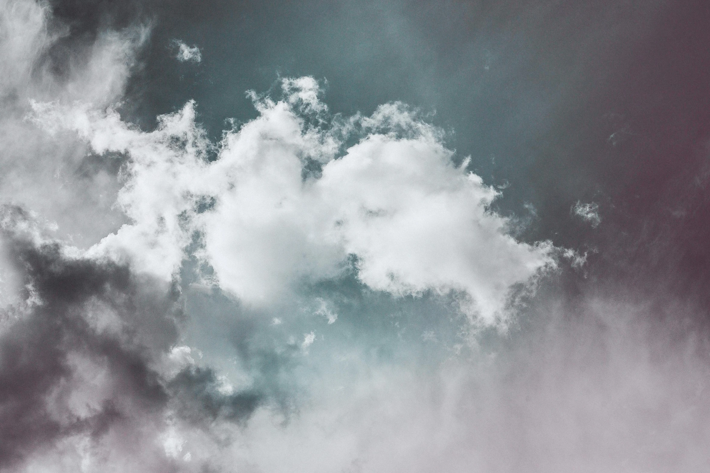 a plane flying through a cloudy blue sky, an album cover, inspired by Elsa Bleda, unsplash, romanticism, ignant, white fluffy cloud, alessio albi, the sky is gray