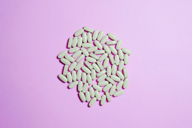 a pile of white pills on a pink background, by Carey Morris, trending on pexels, beans, mint, symmetrical shot, white hairs