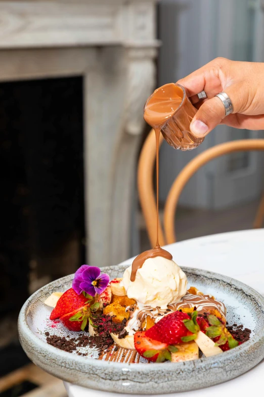 a close up of a plate of food on a table, inspired by Richmond Barthé, unsplash, ice cream on the side, flaming, fully chocolate, manuka