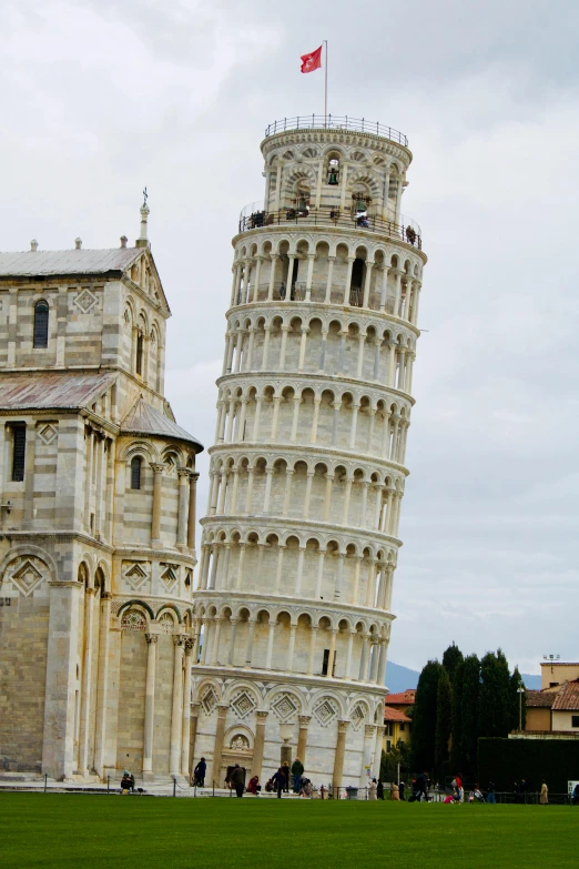 a tall tower sitting on top of a lush green field, inspired by Francesco del Cossa, renaissance, spiral horns!, white marble buildings, pasta, twice