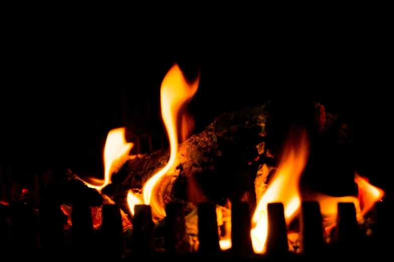 a close up of a fire burning in a fireplace, by David Garner, figuration libre, thumbnail, multiple lights, profile image, wooden logs
