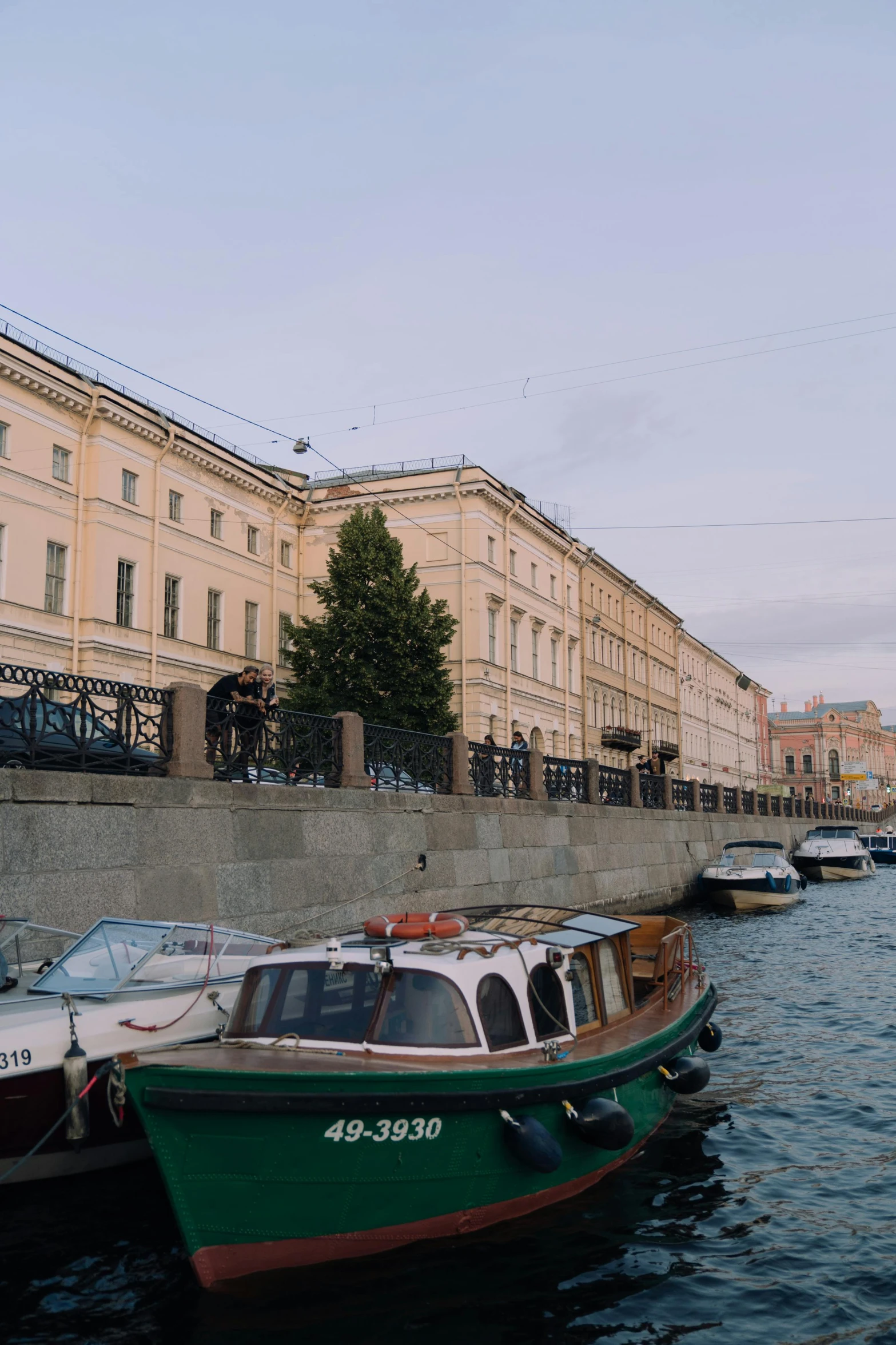 a couple of boats that are in the water, a picture, inspired by Illarion Pryanishnikov, trending on unsplash, renaissance, street of moscow, low quality photo, low quality footage, full building