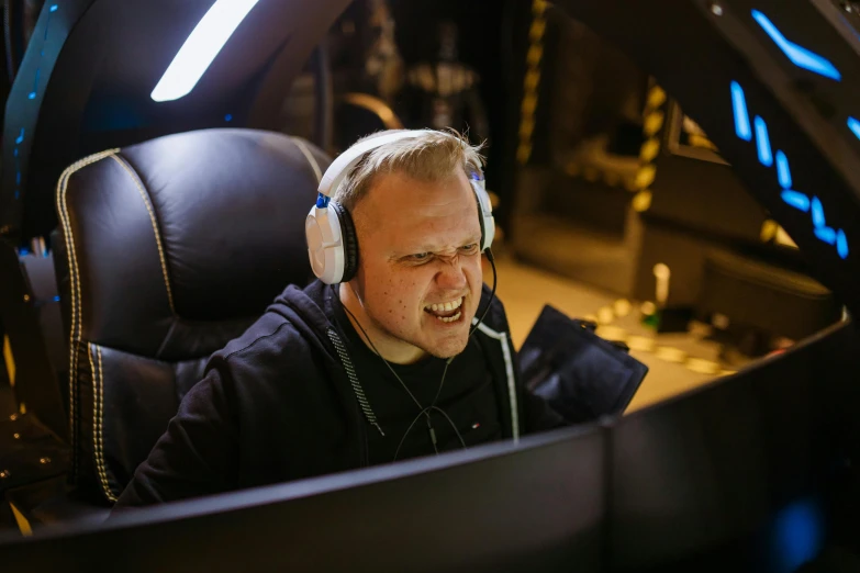 a man sitting in a car with headphones on, gaming computers, head bent back in laughter, avatar image, gwent