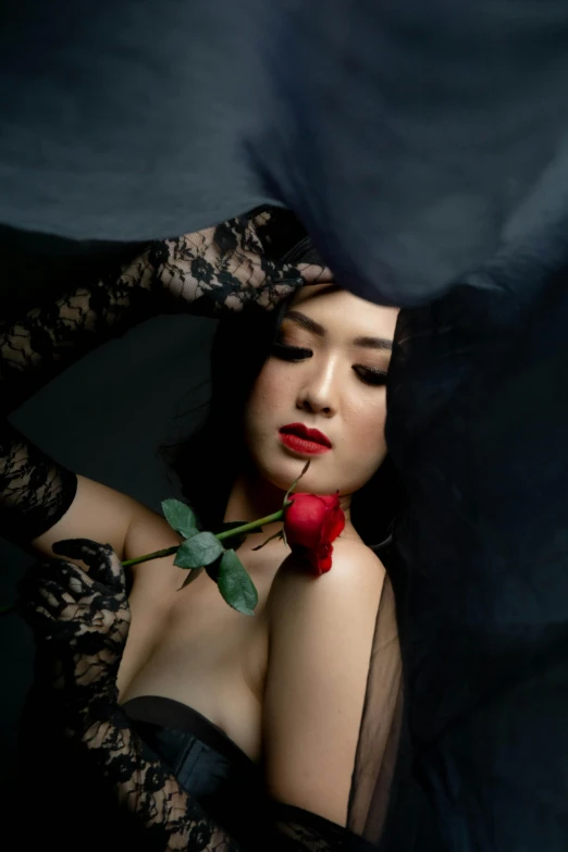 a woman in a black dress holding a rose, inspired by Takato Yamamoto, unsplash, burlesque, vietnamese woman, soft portrait shot 8 k, 奈良美智