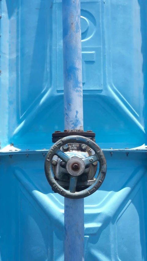 a close up of a metal object in a blue container, unsplash, waterwheels, square, valves, painted metal