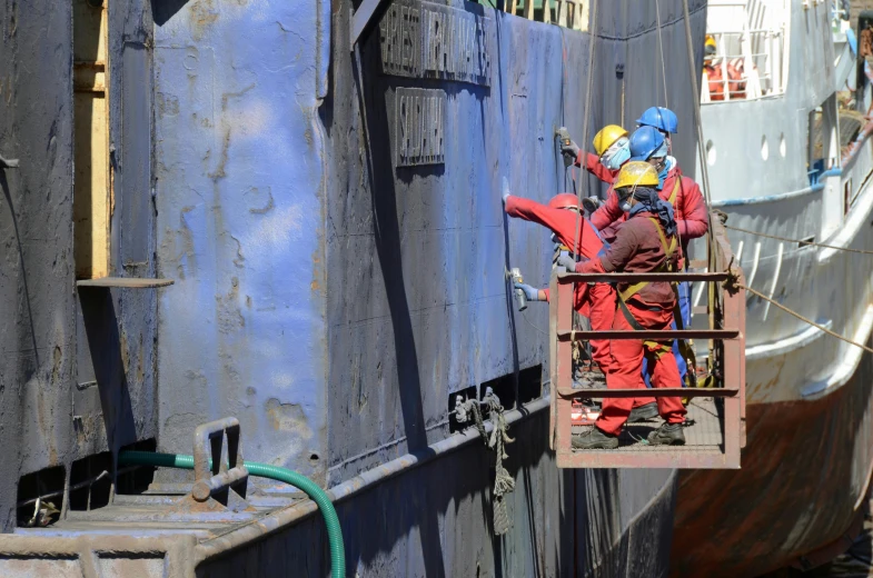 a couple of men standing on top of a boat, industrial colours, bioremediation, blue overalls, thumbnail
