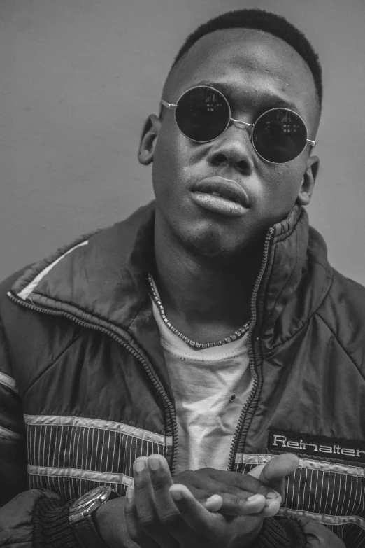 a black and white photo of a man wearing sunglasses, an album cover, by Theo Constanté, unsplash, realism, black teenage boy, sittin, obunga, as well as scratches