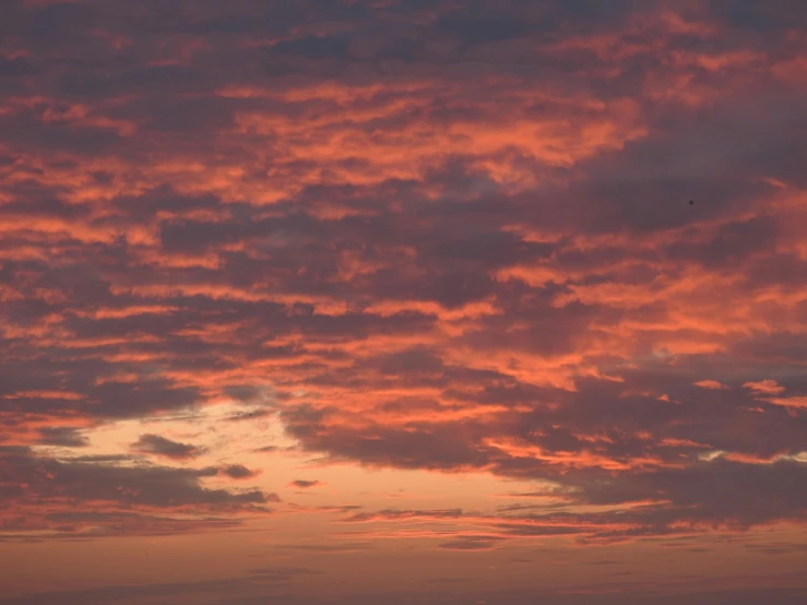 a couple of kites that are flying in the sky, by Charlotte Harding, pexels contest winner, romanticism, redpink sunset, layered stratocumulus clouds, timelapse, # nofilter