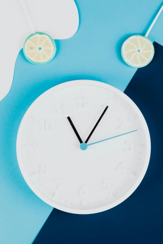 a clock sitting on top of a blue and white table, inspired by Peter de Sève, trending on unsplash, process art, fruit, paper cutouts of plain colors, close face view, humidity