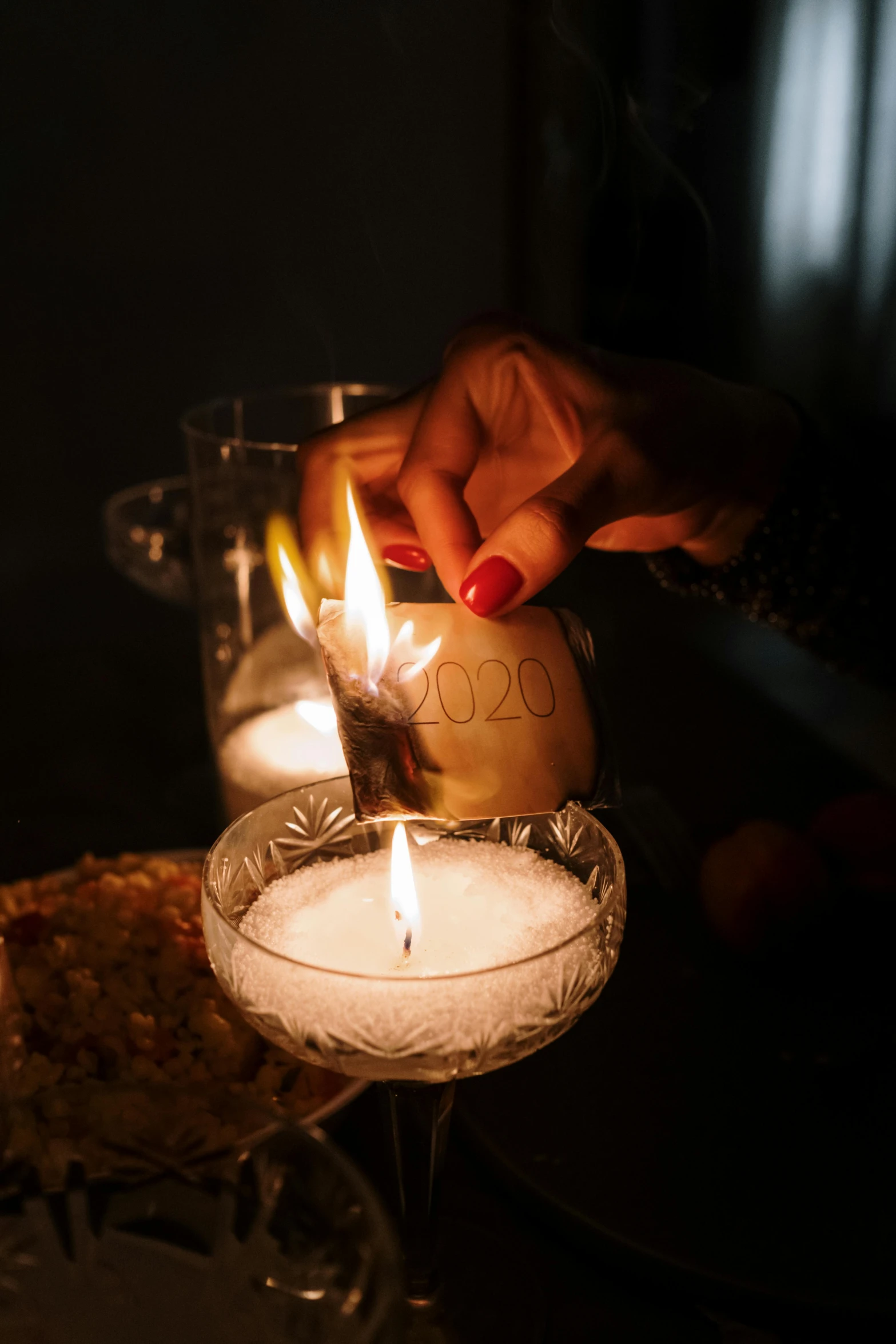 a person lighting a candle in a wine glass, inspired by Elsa Bleda, year 2 0 2 2, close together, a seance, handwritten