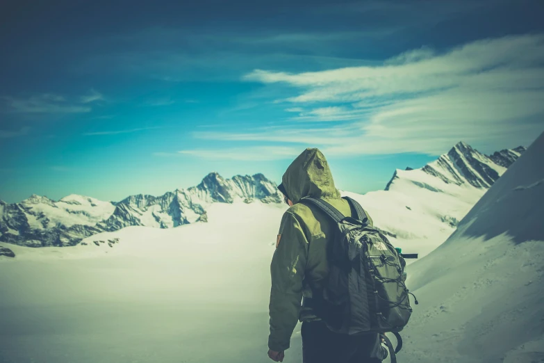 a man standing on top of a snow covered mountain, pexels contest winner, carrying survival gear, avatar image, vintage color, cold place