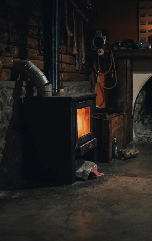 a living room filled with furniture and a fire place, by Sebastian Spreng, pexels contest winner, stove, inside a shed, brown, cold environment