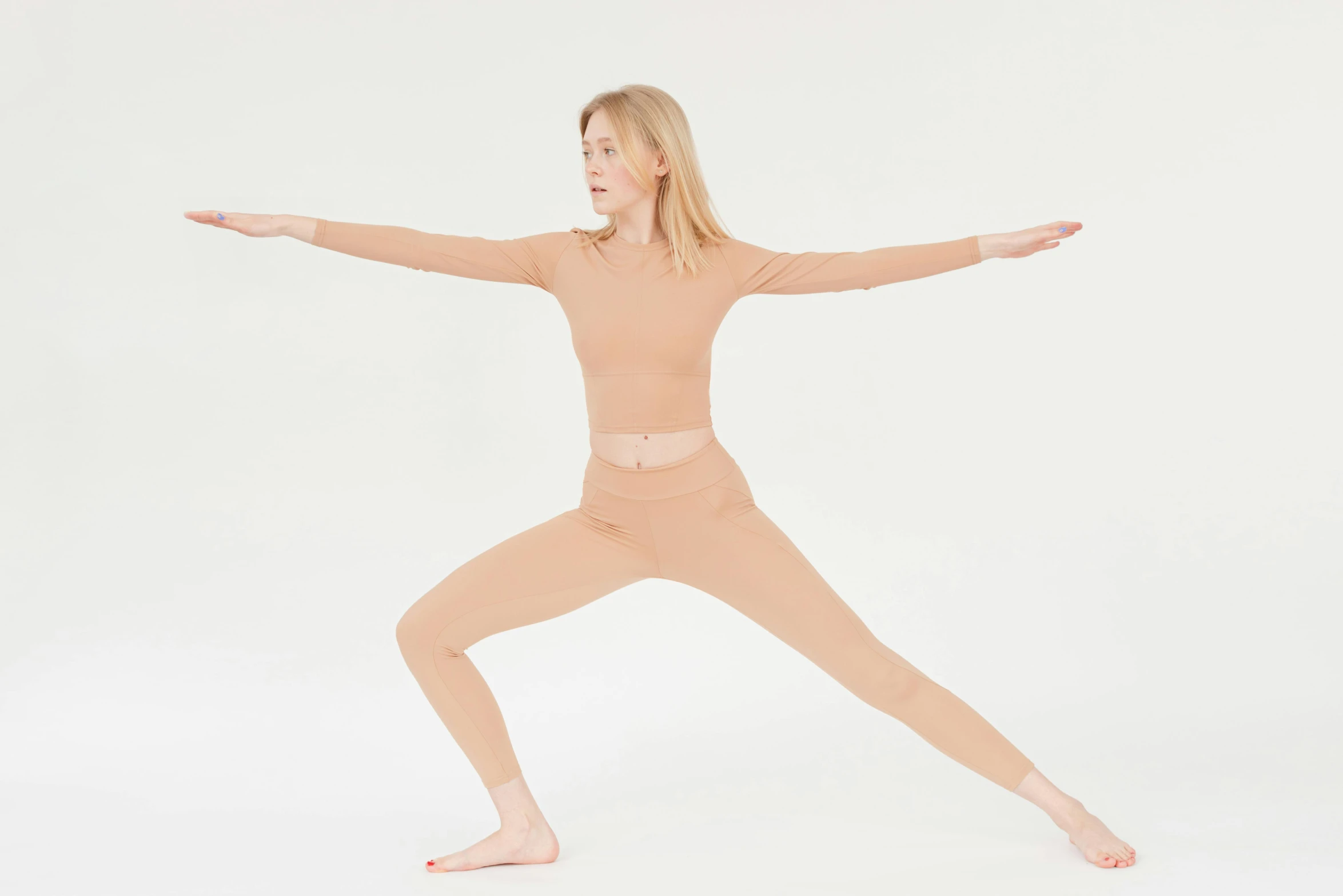 a woman doing a yoga pose on a white background, by Nina Hamnett, arabesque, wear's beige shirt, wearing tight suit, two skinny figures, compression