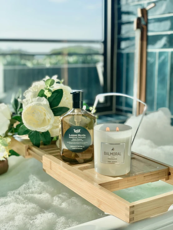 a bath room with a tub a vase of flowers and a candle, by Richmond Barthé, unsplash, baroque, rooftop romantic, on a wooden tray, set on singaporean aesthetic, butterfly in jar