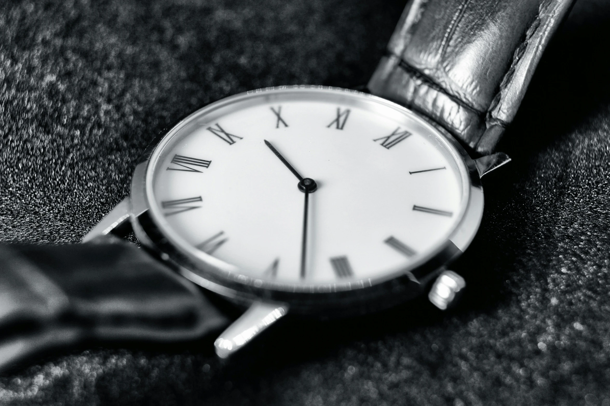 a black and white photo of a wrist watch, by Adam Marczyński, pexels contest winner, minimalism, [ [ hyperrealistic ] ], roman numerals, white soft leather model, on display