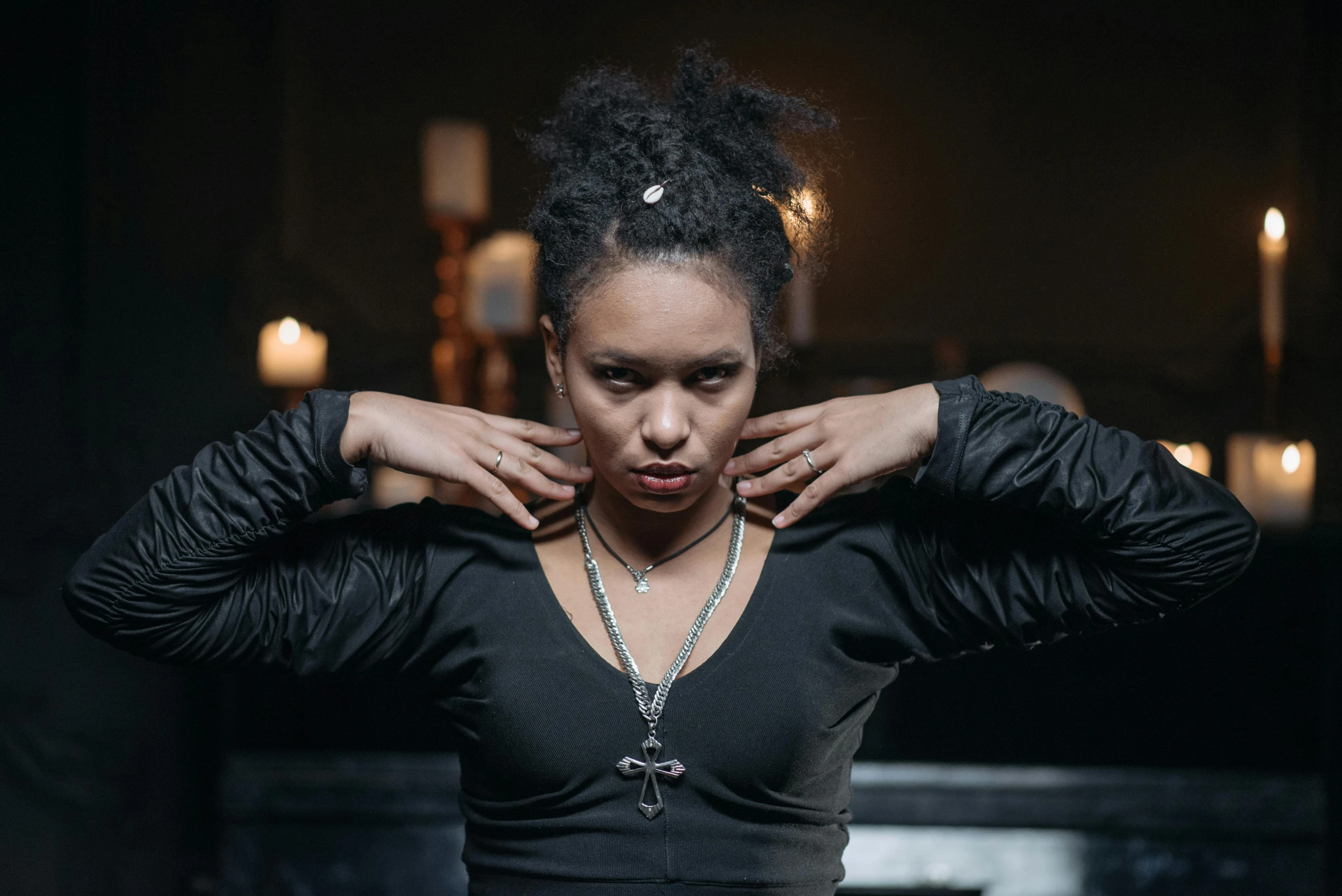 a woman in a black top posing for a picture, an album cover, inspired by Sophia Beale, unsplash, renaissance, bone jewellery, in a dungeon, mixed-race woman, film still from a horror movie