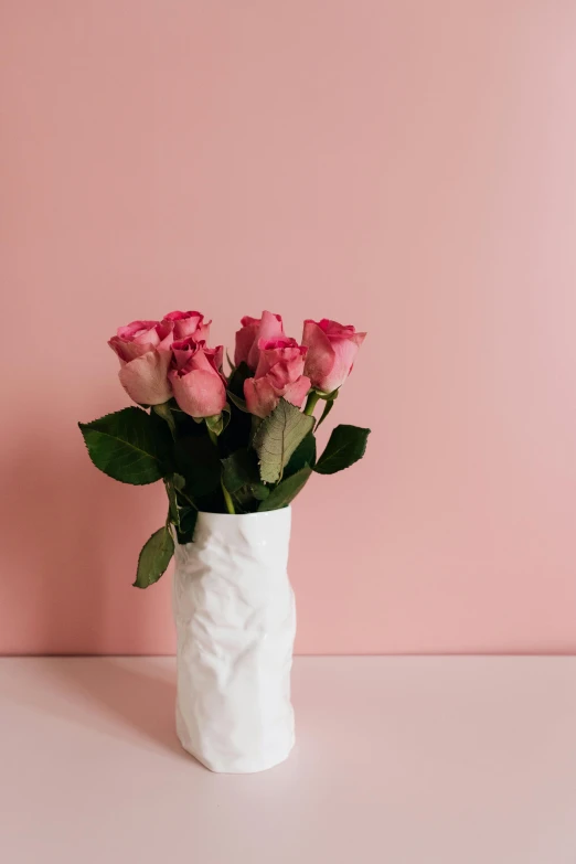 a vase filled with pink roses sitting on a table, inspired by Robert Mapplethorpe, unsplash, romanticism, made of paper, wrinkled, soft vinyl, heartbreak