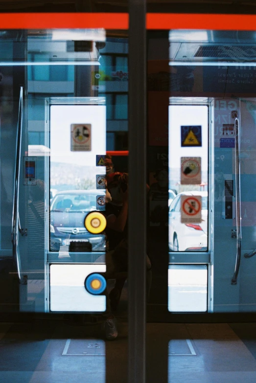 a person standing in front of a vending machine, a hologram, unsplash, hyperrealism, portholes, viewed through the cars window, greece, ( ( ( bauhaus ) ) )