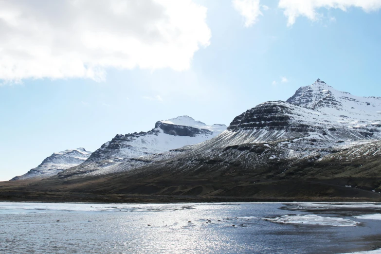 a body of water with a mountain in the background, by Hallsteinn Sigurðsson, pexels contest winner, hurufiyya, snowy plains, background image