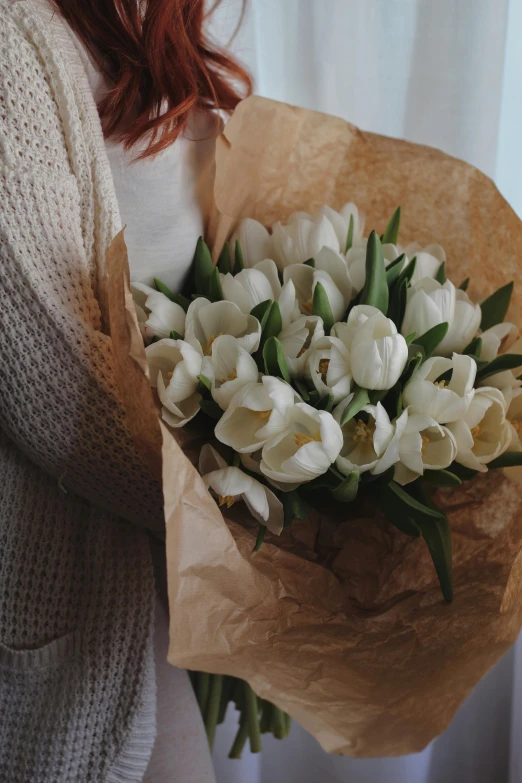 a woman holding a bouquet of white flowers, wrapped in flowers, designed for cozy aesthetics!, tulips, highly textured