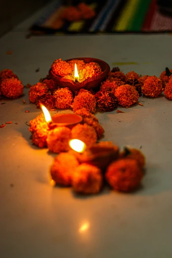 a group of candles sitting on top of a table, hindu ornaments, with orange street lights, fireballs, muck