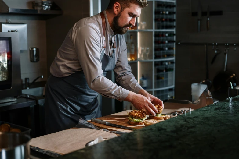 a man in a kitchen preparing food on a cutting board, inspired by Richmond Barthé, pexels contest winner, profile image, fine dining, rectangle, thumbnail