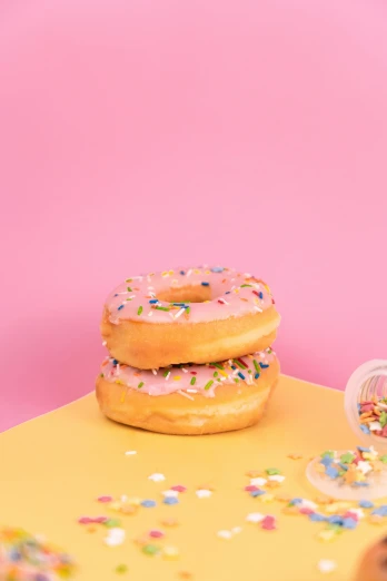 a couple of doughnuts sitting on top of a table, profile image, sprinkles, pink slime everywhere, full product shot