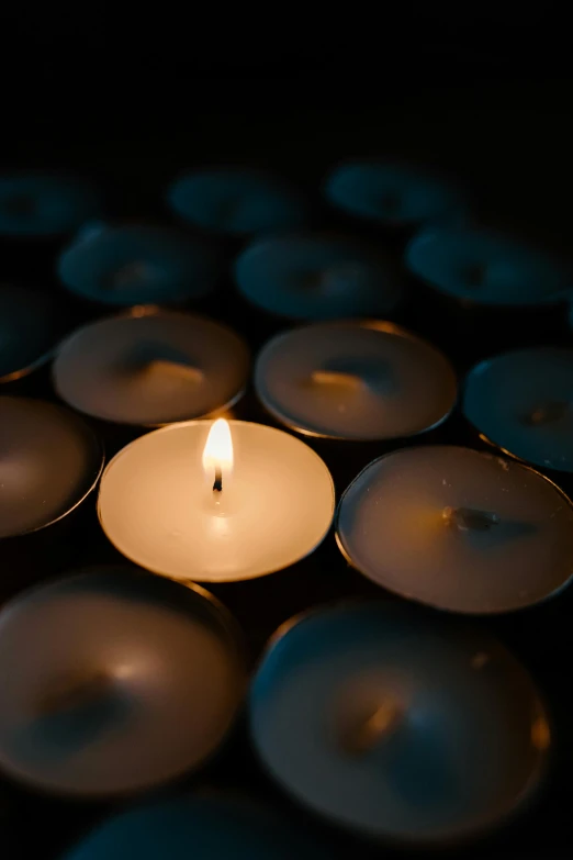 a group of lit candles sitting on top of a table, profile image