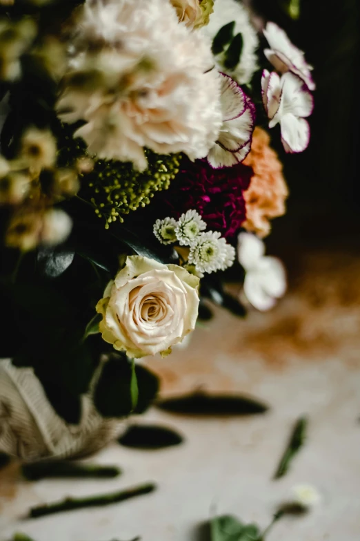 a bouquet of flowers sitting on top of a table, inspired by Louis Buvelot, baroque, upclose, rustic setting, ornamental edges, hauntingly beautiful