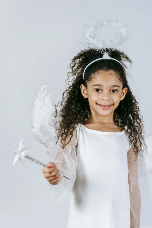 a little girl dressed in a white angel costume, pexels contest winner, renaissance, african american young woman, holding ego weapons, teen elf girl, curls