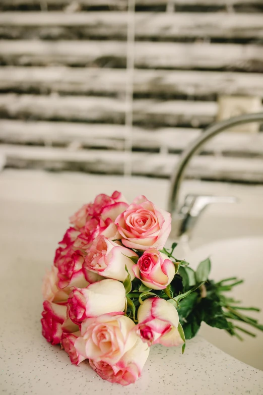 a bouquet of pink roses sitting on top of a sink, inspired by François Boquet, unsplash, romanticism, 3/4 side view, exquisite details, bath, covered in