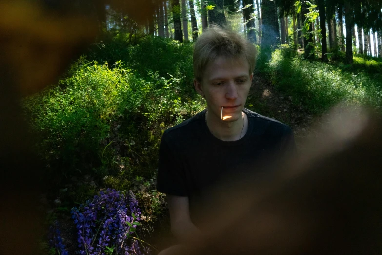 a young man standing in the middle of a forest, by Attila Meszlenyi, unsplash, cigarette in his mouth, thin young male alchemist, avatar image, medium format. soft light
